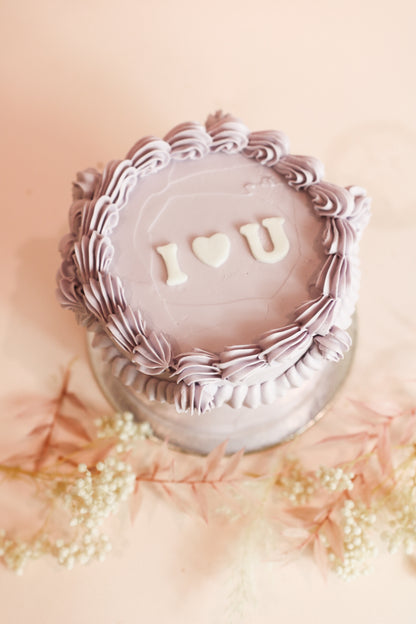Lilac bento vintage cake with lilac cream decor and white caption I love you
